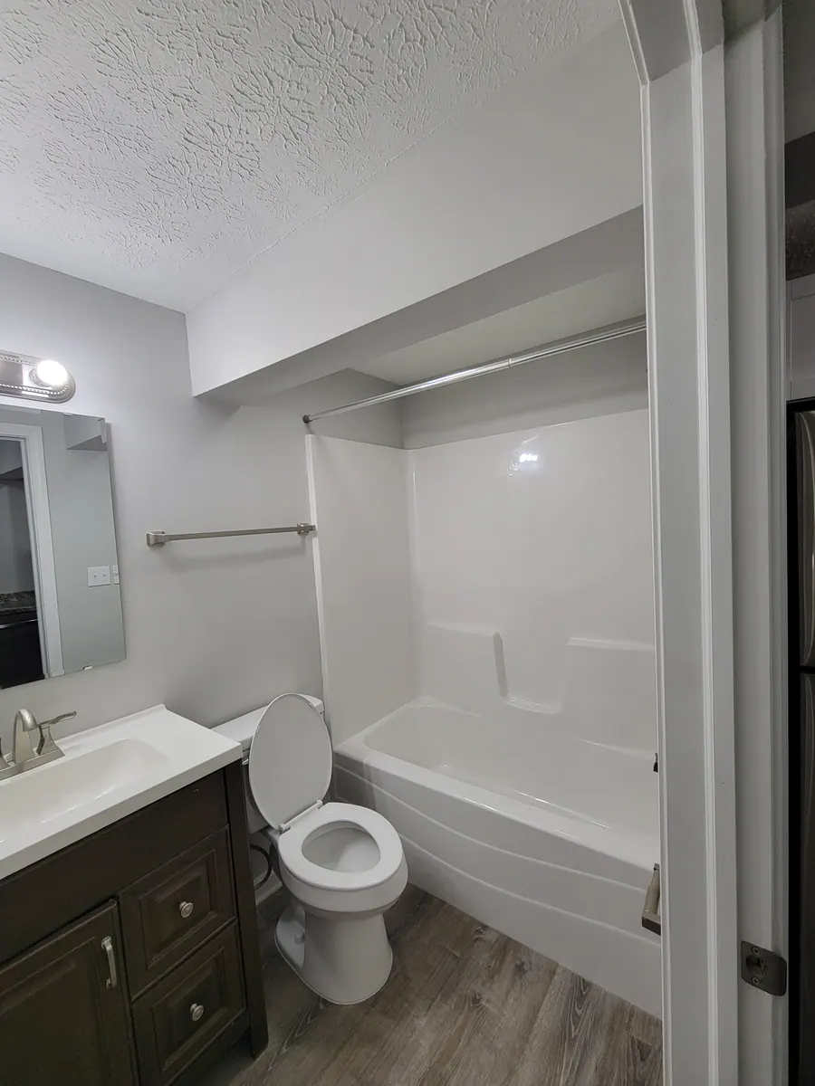 Studio bathroom with vanity and bathtub