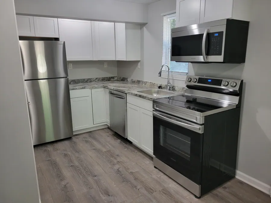 Studio kitchen with white cabinets and stainless-steel appliances